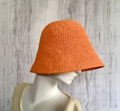 Crochet raffia hat It is a classic accessory for every woman for sun protection, summer parties, beach and travel. Can be a good gift for a woman of any age. The cap is crocheted from natural raffia, light, elastic, the brim of the cap is reinforced with wire. The hat keeps its shape well and does not fade in the sun. The cap is soft to the touch, slightly rough. It is fully crocheted. Easy to carry with foldable design. The hat is perfect for summer wardrobe. Color: Orange Field Size: about 3 inches Care of the product:        It is better to dry the hat naturally, without using additional heating sources. When the raffia product dries, it returns to its original shape.        You cannot wash them in the usual way. If it gets dirty, clean it with soapy water and a sponge. The surface is g Orange Short Brim Sun Hat For Vacation, Woven Brimmed Bucket Hat For Warm Weather, Orange Brimmed Sun Hat For Summer, Orange Brimmed Sun Hat For Vacation, Orange Wide Brim Sun Hat, Handwoven Bucket Hat For Spring Vacation, Brimmed Crochet Summer Hat, Woven Bucket Hat With Short Brim For Warm Weather, Woven Cloche Hat For Summer