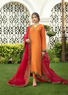 Burnt orange Rawsilk kaftan kurta with handwork on neckline & embalishments on slevees and front & back ghaira chak with tilla, zardozi & dabka. Paried with a bright Fuscia colored embossed organza duppata with emerald green borders & similar work on 4 sides. Designer Orange Salwar Kameez, Festive Chanderi Kaftan With Mirror Work, Eid Dabka Embroidered Georgette Kaftan, Eid Dabka Embellished Georgette Kaftan, Georgette Kaftan With Resham Embroidery, Unstitched Kaftan With Mirror Work For Navratri, Eid Georgette Unstitched Kaftan, Eid Anarkali Style Raw Silk Kaftan, Eid Unstitched Georgette Kaftan