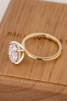 a diamond ring sitting on top of a wooden box