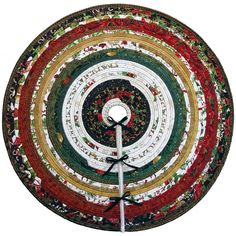 a multicolored round table top with a clock on it