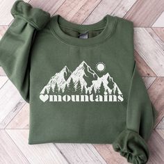 This Mountain Themed Sweatshirt is a perfect gift for all nature lovers who love the outdoors.  Also this Mountains Sweatshirt makes a perfect family vacation shirt.  Whether it's a gift for mom or dad, trail runners, cross country or hikers, they are sure to love it!   SUPER SOFT AND COZY CREWNECK SWEATSHIRTS AND HOODIES S H I R T / D E T A I L S Our sweatshirts are SUPER soft and SUPER comfy. For Women They Run Oversized! 50% Cotton/50% polyester and pre-shrunk.  We Use Soft and Cozy Gildan 18 Spring Outfits Mountains, Mountain Sweatshirt Design, Outdoor Long Sleeve Sweatshirt With Letter Print, Long Sleeve Sweatshirt With Letter Print For Outdoor, Long Sleeve Letter Print Sweatshirt For Outdoor, Hooded Winter Hiking Tops, Hooded Winter Tops For Hiking, Casual Fleece Sweatshirt For Hiking, Casual Fleece Sweater For Outdoor Activities