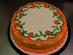 a cake with orange and green decorations on it