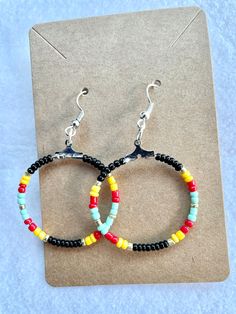 Dainty beaded hoop earrings bring a pop of color to your outfit of the day! Trendy Hoop Beaded Earrings For Pierced Ears, Summer Small Hoop Beaded Earrings For Pierced Ears, Summer Hoop Earrings With Colorful Beads, Adjustable Beaded Circle Earrings For Summer, Colorful Beaded Circle Earrings For Summer, Colorful Circle Beaded Earrings For Summer, Trendy Round Beaded Earrings With Ear Wire, Trendy Small Hoop Beaded Earrings, Trendy Festival Hoop Earrings With Colorful Beads