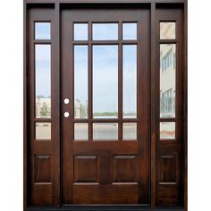 a wooden door with two sidelights and glass panels on the front entrance to a building