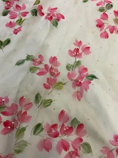 pink flowers on white fabric with green leaves