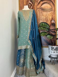 Readymade chinos sage green and blue heavy embroidered Sharara Suit, Punjabi Salwar suit. It is available for fast delivery. Indian Pakistani wedding dress Details Sharara/Salwar/Plazzo Fabric: Chinon Colour : Sage green and blur Inner: Crape lined Design: Huge flair with heavy embroidery on the Sharara Kameez/Shirt/Kurti Fabric: Chinon Colour: Sage green Inner : Crape lined Design:Heavy embroidery on neck and hem of the shirt Dupatta Fabric : Georgette Color: Sage green Design :Beautiful dupatt Transitional Green Anarkali Set With Dabka, Green Resham Embroidery Kurta For Transitional Season, Green Lehenga With Resham Embroidery For Transitional Season, Transitional Green Kurta With Resham Embroidery, Transitional Green Lehenga With Resham Embroidery, Traditional Green Sharara For Designer Wear, Bollywood Style Green Kurta, Green Bollywood Style Kurta, Transitional Green Anarkali Sharara