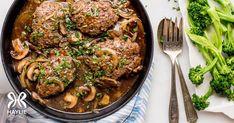 meatballs and mushrooms are in a skillet with broccoli on the side