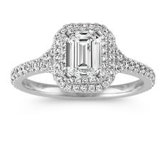 an emerald cut diamond engagement ring with pave set shoulders