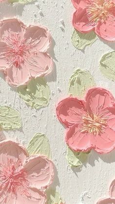 some pink flowers are on a white surface