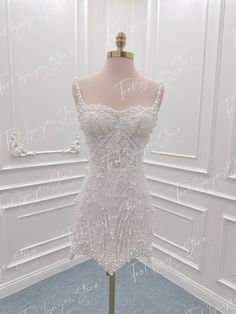 a dress on display in front of a white wall