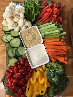 vegetables and dip are arranged on a platter