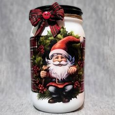 a glass jar with a santa clause on it