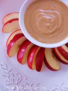 a plate with apples and peanut butter on it