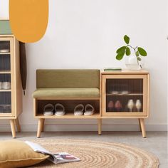 a living room with a couch, bookshelf and shoes on the floor in front of it