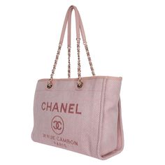 Authentic NEW Chanel Deauville pink canvas large shopping tote. The bag can be carried on the handle or worn over the shoulder. Features pink woven leather shoulder straps, top center snap closure, gold-tone hardware, two interior slip pockets and a zip pocket, Chanel Paris logo on the front exterior, and pink interior lining. Made in Italy 2020 Hologram stamp and the card read: 30163798 Handle drop: 4.5" Strap drop: 10.5" Luxury Pink Tote Box Bag, Luxury Large Capacity Pink Shoulder Bag, Chic Canvas Bags With Rolled Handles, Chic Canvas Bag With Rolled Handles, Luxury Canvas Bag For Shopping, Luxury Pink Shoulder Bag For Travel, Luxury Double Handle Canvas Bag For Shopping, Luxury Pink Coated Canvas Bag, Luxury Large Capacity Canvas Bag For Shopping