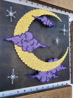 an image of a crocheted moon on the side of a building