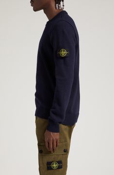 Stone Island's adventure-ready aesthetic is evident in the warm wool blend and military-inspired compass logo branding this cozy crewneck sweater. 27" length (size Medium) Crewneck Long sleeves 80% wool, 20% polyamide Dry clean or hand wash, dry flat Imported Designer Clothing Casual Winter Sweater With Logo Patch, Crew Neck Sweater With Logo Patch For Fall, Crew Neck Sweater With Logo Patch For Winter, Casual Wool Crew Sweatshirt, Fall Crew Neck Sweater With Logo Patch, Winter Crew Neck Sweatshirt With Logo Patch, Winter Cotton Sweater With Logo Patch, Winter Crew Neck Sweater With Logo Patch, Wool Crew Neck Sweater For Streetwear