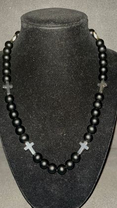 Grab this custom Blackout all Black inspired beaded necklace.  All matte black Beaded Necklace with Silver Crosses!   20in w/ magnetic clasp for easy and comfort. Great for all occassions! Elevate your style AND your game with our vibrant, handcrafted beaded necklace.   Look Good, Feel Good, Feel Good Play Good! BLING BLING ⚾️🏈⚽️🏀⚾️️ 📿 Baseball Football Soccer Softball Basketball 🌟 Features: 🌟 Versatile Wear 🌟 Unique Design 💎 Quality Matters: Thick Elastic band and magnetic clasps ensure durability and long-lasting wear. 📸 Instagram-Ready: Be prepared for compliments and photo ops wherever you go! Follow @DingerCityDrip Black Silver White Cross Beaded Necklace Fruit Loop Phillies Yellow Orange Green Teal Rhinestone Bead Beaded Chain Blue Pink Red Green Baseball Wander Franco Cabrer Black Jewelry With Beaded Chain And Round Beads, Handmade Black Necklaces With Round Beads, Black Beaded Chain Beads As Gift, Black Spiritual Beaded Necklaces With Polished Beads, Black Beaded Chain As A Gift, Adjustable Black Beaded Necklaces With Round Beads, Black Beaded Necklaces With Large Beads, Spiritual Black Beaded Necklaces With Round Beads, Black Beaded Chain For Gift