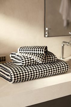 two black and white towels sitting on top of a counter