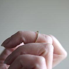 This delicate and luxurious solid 14k or sterling silver simple stacking ring is an absolute classic favorite. The design is clean and simple, and the texture adds a little boho geometric feel. It can be worn as a simple wedding band, or layered with myriad other rings to create a beautiful stack. Made from solid 14k yellow gold or sterling silver twisted wire, formed, soldered and then hammered. The width of the band is just over 1mm. The stack image shows the Simple Twist on the bottom, along Simple Stackable Midi Rings With Open Band, Delicate Everyday Stackable 14k Gold Rings, Simple Stackable Open Band Rings, Minimalist Stackable Rings With Simple Round Band, Dainty Hammered Midi Rings For Anniversary, Simple Open Stackable Rings, Minimalist Stackable Rings With Round Band For Promise, Everyday Delicate 14k Gold Stackable Rings, Simple Everyday 14k Gold Stackable Rings