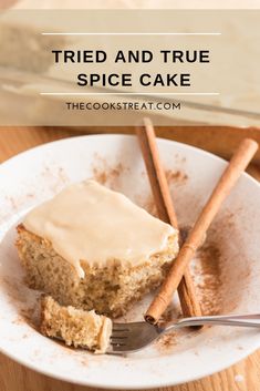 a piece of cake on a plate with cinnamon sticks