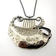 "This unique pendant is made of sterling silver and a beautiful shell. This stunning piece is the perfect gift for yourself or a loved one. DIMENSIONS - Max Length: 48 mm / 1.92 inches - Max Width: 55.5 mm / 2.22 inches - The length of the chain is usually 18\"- 22\", yet can be made at any size you wish. - If you are interested in a specific length, please write a note on checkout. NOTES -  It comes in a beautiful jewelry gift box. - We can also add a personal note in case you would like us to Silver Hammered Pendant Jewelry, Hand Cast Silver Artisan Necklace, Hammered Sterling Silver Necklaces In Silver, Unique Silver Hammered Jewelry, Unique Hammered Silver Jewelry, Hammered White Gold Pendant Necklace, White Gold Hammered Pendant Necklace, Artistic Silver Necklaces With Polished Finish, Spiritual Hammered Sterling Silver Necklaces