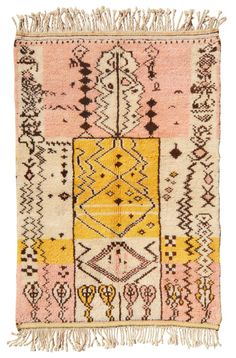 a pink and yellow rug with fringes on the bottom, in different shapes and sizes