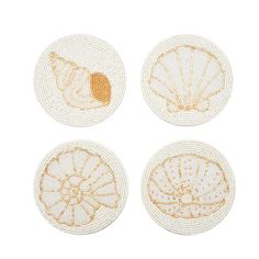 four coasters with shells on them in gold and white thread, each decorated with an embroidered design