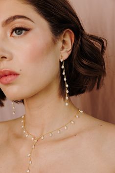 Add a touch of graceful elegance to your bridal look with the Whispering Pearl Drop Earrings! These stunning dangle earrings feature freshwater pearls delicately hanging from a fine gold chain, creating a perfect balance of timeless beauty and modern sophistication. Why do we love them? They’re the perfect blend of chic and classic beauty, making them a must-have for your special day! EARRING FEATURES Material: Brass, Freshwater Pearls Dimensions/Size: 3.2" drop Finish: Polished 14k Gold Plating Bridal Look, Classic Beauty, Pearl Drop Earrings, Pearl Drop, Bridal Looks, Gold Plating, Timeless Beauty, Gold Chain, Gold Chains