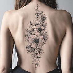 the back of a woman's body with flowers on it and leaves around her neck