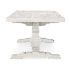 a white table sitting on top of a wooden floor