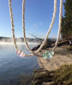 "White chokers with a sea glass middle! D E T A I L S This choker is made on a flexible wire for added comfort and durability. The closure is a lobster clasp. There is an extension chain so you can wear it to fit wherever you want on your neck. S I Z I N G This choker is approximately 14\" with a 2.5\" extension chain. If you would like a different size, please read below! How to request a different length: 1. Add this listing to your cart ($1 per item that you would like a different size for): Summer Choker, Rainbow Choker, White Choker, Popular Necklaces, Beach Necklace, Bead Choker, Beach Necklaces, Boho Choker, Summer Necklace