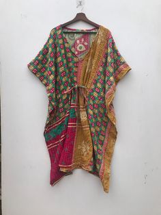 A vintage Kantha kaftan sounds like a beautiful fusion of cultural heritage and fashion. Kantha is a traditional embroidery technique from the Indian subcontinent, particularly prevalent in West Bengal and Bangladesh, where layers of old saris and dhotis are stitched together to create new textiles. Kaftans, on the other hand, have a long history in various cultures, often associated with loose, flowing garments worn in many parts of the world. Combining the two, a vintage Kantha kaftan would li Bohemian Kaftan With Patchwork And Kimono Sleeves, Bohemian Patchwork Kaftan With Kimono Sleeves, Multicolor Ikat Print Kaftan For Festive Occasions, Green Bohemian Kaftan For Festive Occasions, Traditional Bandhani Print Kaftan For Festivals, Multicolor Ikat Print Kaftan Tunic, Bohemian Kimono With Block Print, Bohemian Block Print Kimono For Festivals, Multicolor Patchwork Kaftan With Kimono Sleeves