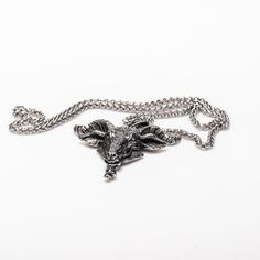 Stunningly intricate and made from durable alloy steel, the Goat Head Necklace boasts a large 2.5 by 2.3 inch pendant, complemented by a sturdy 25 inch double link chain. Premium craftsmanship exudes from every inch of this piece. Antique Silver Large Pendant Metal Jewelry, Antique Silver Metal Jewelry With Large Pendant, Antique Silver Large Pendant Jewelry, Oxidized Metal Pendant Chain Necklace, Metal Chain Necklace With Oxidized Finish Pendant, Silver Metal Chain Necklace With Wheat Chain, Silver Metal Jewelry With Wheat Chain, Silver Jewelry With Wheat Chain, Engraved Metal Pendant Chain Necklace