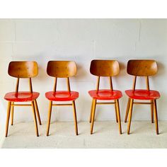 three red chairs sitting next to each other