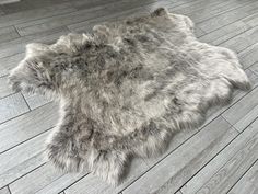 an animal skin rug is laying on the floor