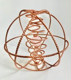 a wire sculpture is shown on a white surface