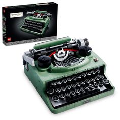 an old fashioned green typewriter with its box open