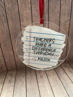 a glass ornament with writing on it that says teachers make a difference everyday mason