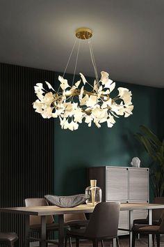 a chandelier hanging from the ceiling over a dining room table