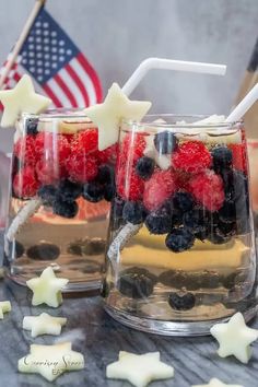 two glasses filled with fruit on top of a table next to stars and an american flag