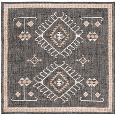 a gray and white rug with an intricate design on the front, in different colors