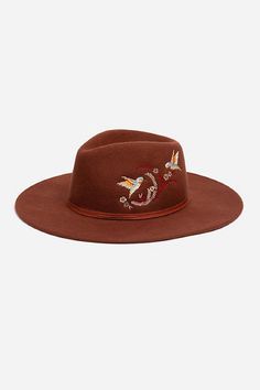 Crafted from 100% wool, the Hummingbird Heather Hat is available in an earthy rust color. Featuring a mid-height crown and a wide brim, this hat is finished with intricate placement embroidery and a decorative feather placed thoughtfully at the hatband. Style with a denim-on-denim look and western style boots for an eclectic ensemble. Johnny Was Women's Hummingbird Feather Hat in Rust Brown, Denim Brown Wide Brim Felt Hat For Fall, Brown Felt Hat With Curved Brim For Fall, Spring Brown Wool Felt Hat, Brown Flat Crown Felt Hat For Spring, Brown Felt Hat For Fall Rodeo, Brown Felt Hat For Rodeo In Fall, Brown Felt Hat With Flat Crown For Fall, Fall Rodeo Brown Felt Hat, Brown Fedora For Rodeo In Fall