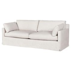 a white couch with two pillows on it