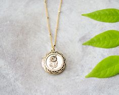 Lovely gold flower engraved locket pendant. Round Flower Charm Jewelry For Keepsake, Round Keepsake Jewelry With Flower Charm, Dainty Medallion Charm Necklace As Keepsake, Gold Jewelry With Flower Charm Keepsake, Gift Medallion Necklace With Vintage Charm, Dainty Engraved Medallion Locket Necklace, Dainty Medallion Keepsake Jewelry, Gold Flower Pendant Jewelry With Vintage Charm, Mother's Day Rose Gold Round Locket Necklace