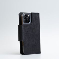 an iphone case is shown with the back cover open and it's black leather