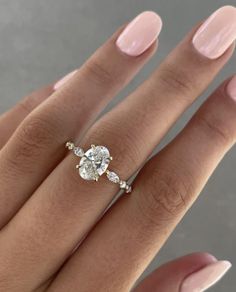 a woman's hand with a diamond ring on it