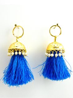 These earring are the epitome of the Punjabi culture. Made with gold plated metal, simple lines and cuts will leave you in awe. The shanshan sound of these Jhumka will mesmerise and take you to your dreamland. The Blue tassles and pearls will add colour to your outfit and occasion. Perfect for Jago, sangeet, party and weddings. Gold Plated Metal, Faux Pearls, Blue Threads Handcrafted in India with love and care Style No. 1034 Closure: Continuous Hoop DIMENSIONS Approx 2"L, 1"W SHIPPING & RET