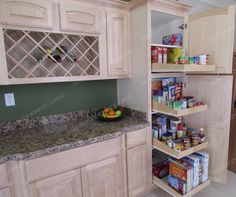 a kitchen with wooden cabinets and shelves filled with food