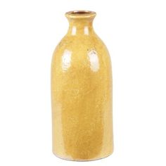 a yellow vase sitting on top of a white table